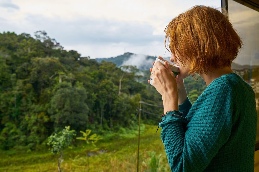 A woman drinking coffee in nature
